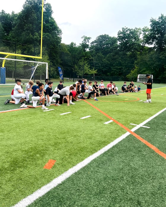 football_coach_team_talk_field