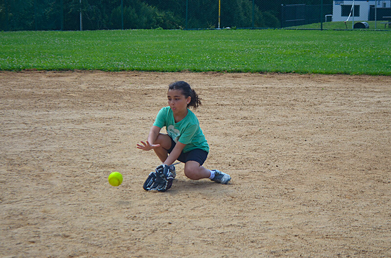 girl catching softball camp