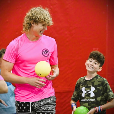 multi-sport - coach and camper smiling dodge ball