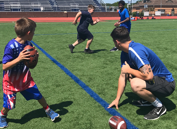 NAS_flag_football_coach_boys_drill