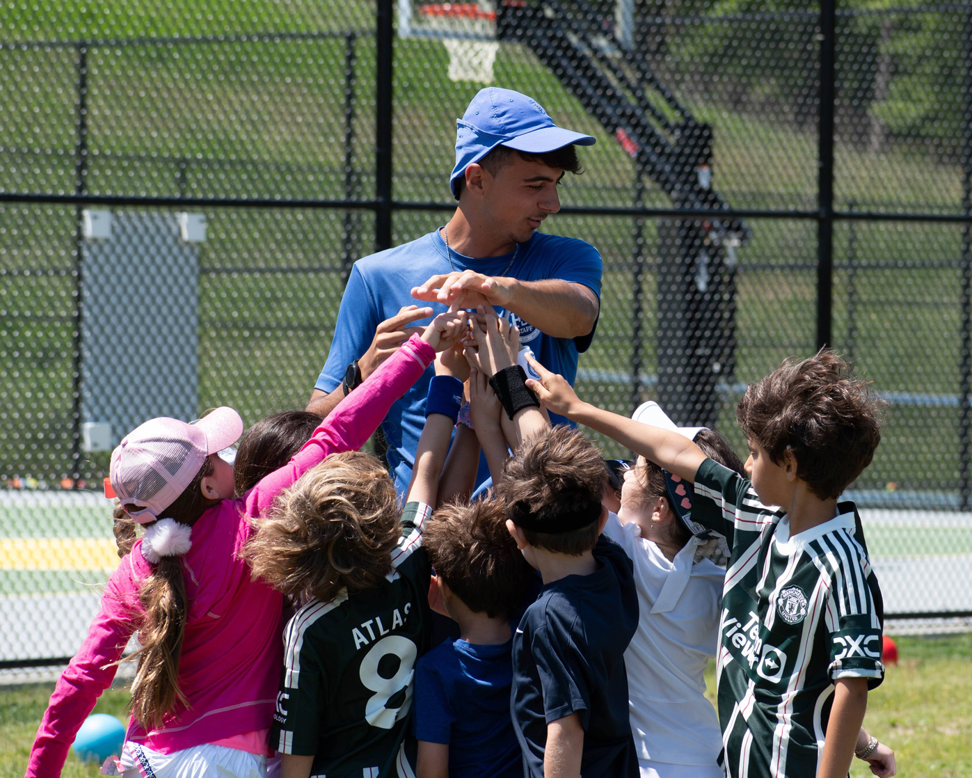 SH_soccer_team_hands_coach